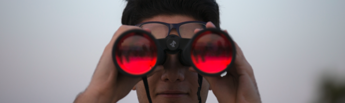Person looking into binoculars