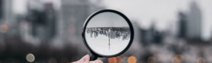 hand holding magnifying glass